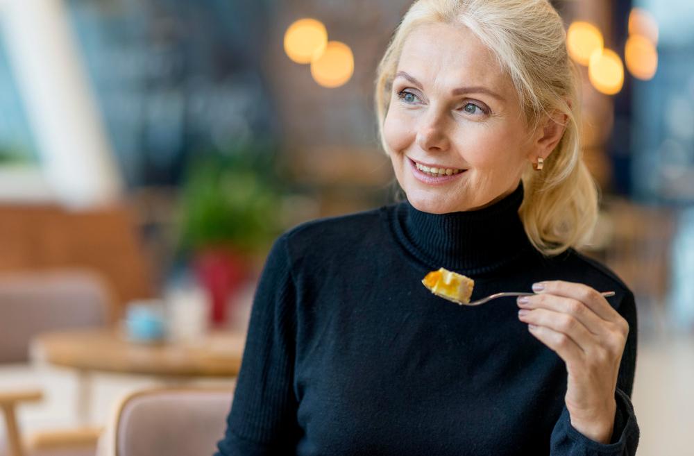 Front View Smiley Elder Business Woman Having Dessert While Working