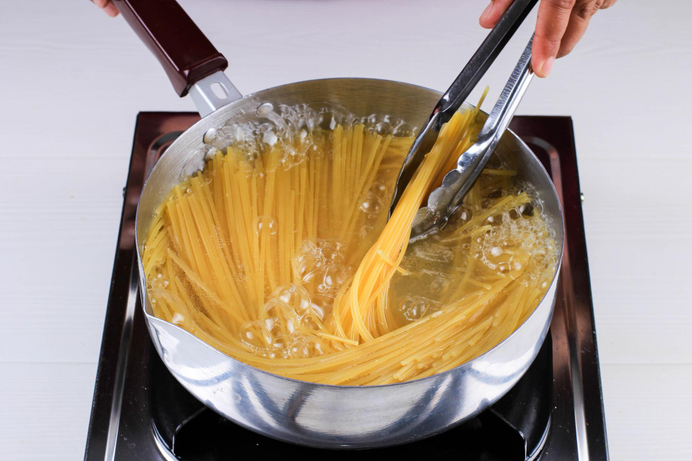 Women Cooking Spaghetti Pan Boiling Water Kitchen