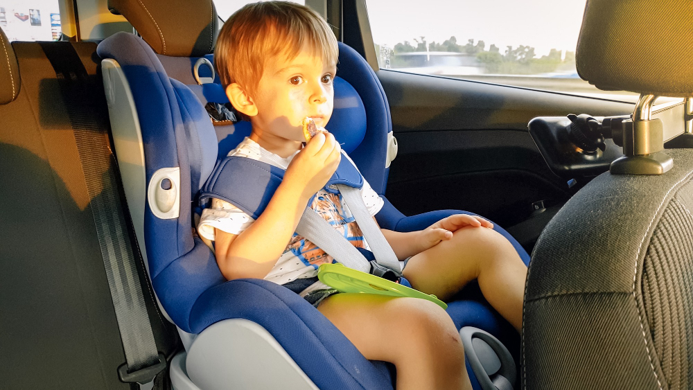 little-toddler-boy-feeling-hungry-eating-while-travelling-by-car-child-safety-seat