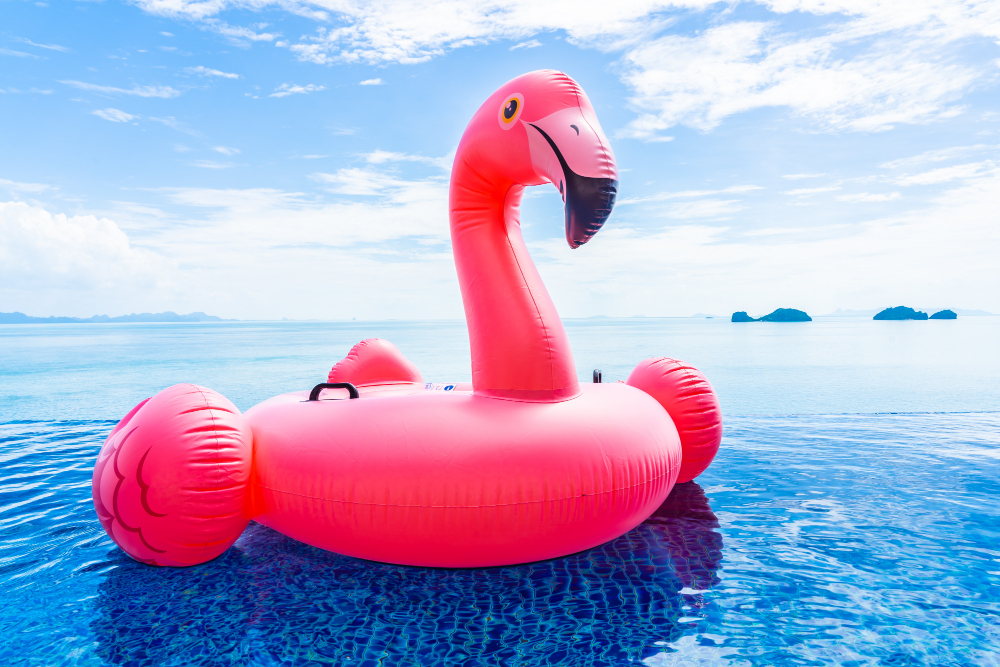 Beautiful Outdoor Swimming Pool Hotel Resort With Flamingo Float Around Sea Ocean White Cloud Blue Sky