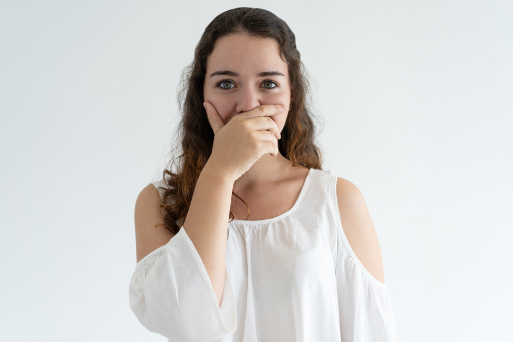 Embarrassed Lovely Woman Covering Mouth With Hand