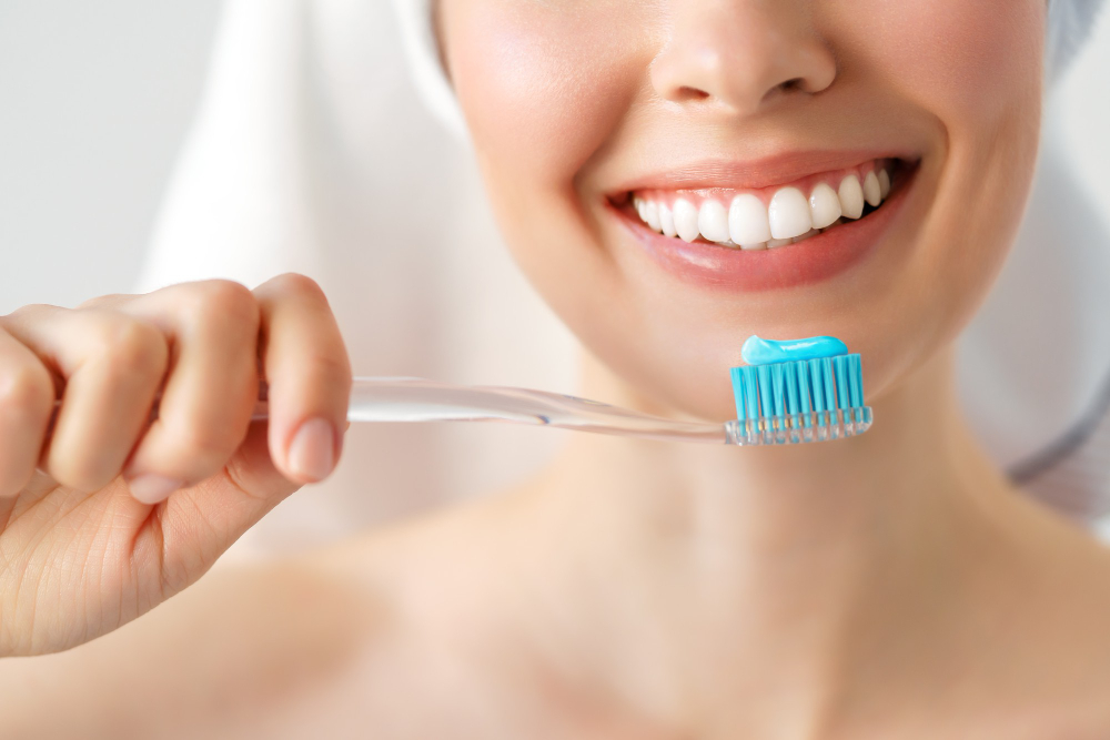 Smiling Woman Cleaning Her Teeth With Toothbrush Dental Hygiene Concept Isolated White