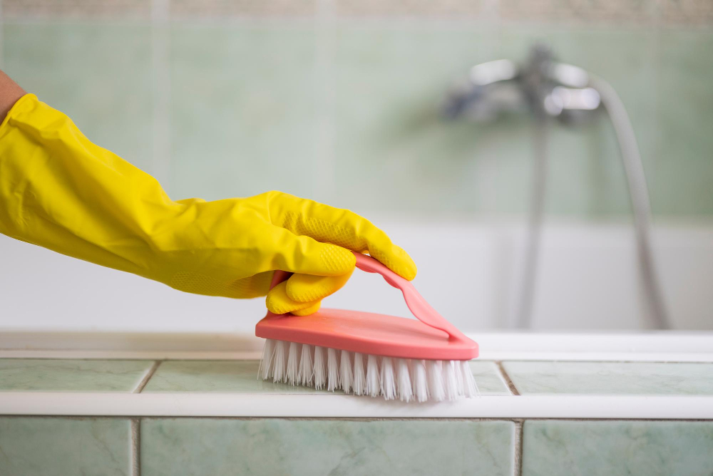 Person Cleaning Bathroom With Brush