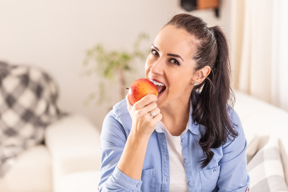 Beautiful Brunette Woman Sitting Living Room Biting Off Apple