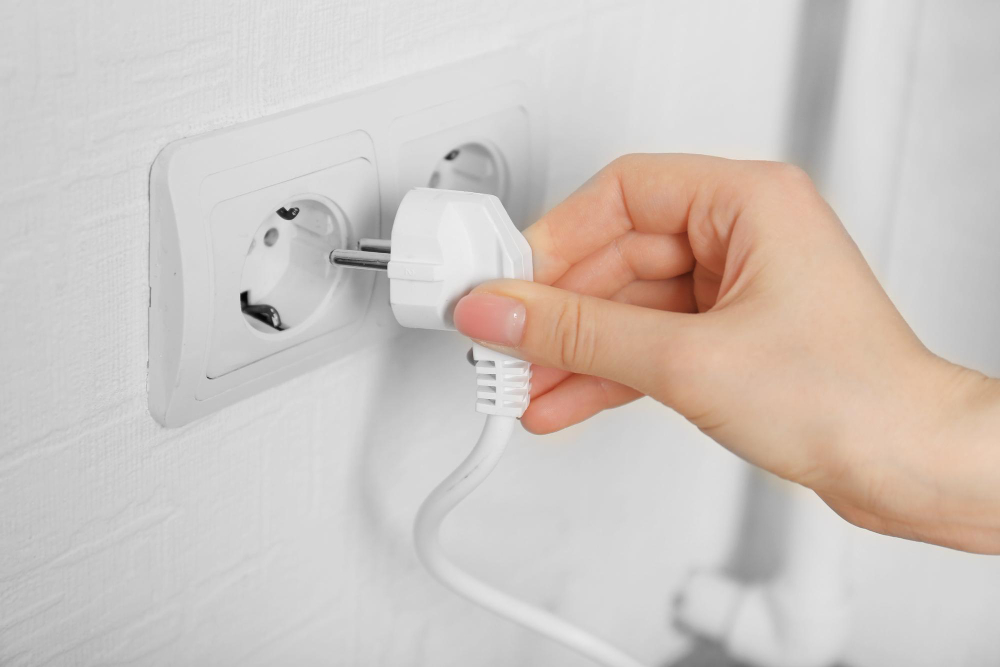 Hand Putting Plug Electricity Socket Close Up