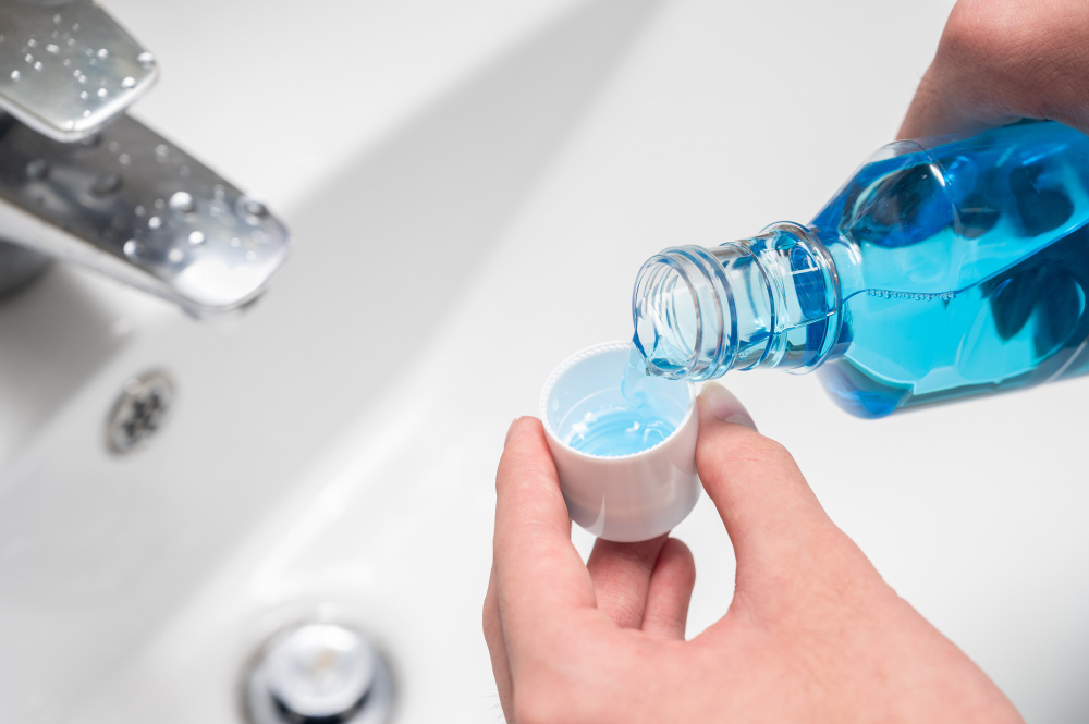 Hand Man Pouring Bottle Mouthwash Into Cap