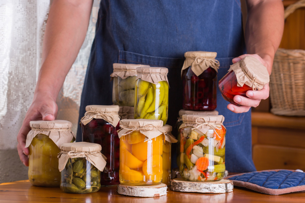 young-man-holding-hands-jars-with-homemade-preserved-fermented-food-pickled-marinated-harvest-preservation-local-produce-from-farmers