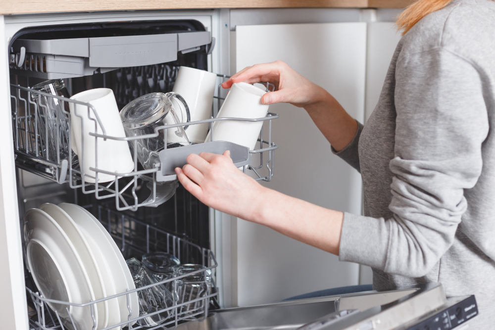 housework-young-woman-putting-dishes-dishwasher