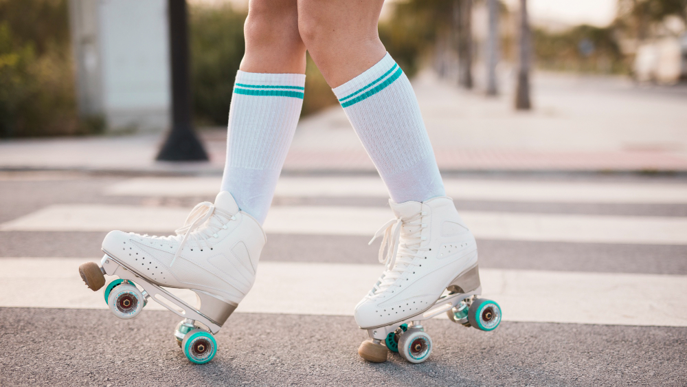low-section-woman-wearing-vintage-roller-skate-walking-road