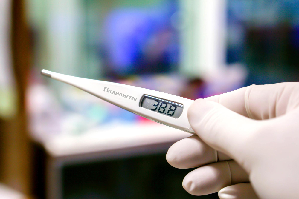 closeup-medical-thermometer-hands-doctor-blurry-background