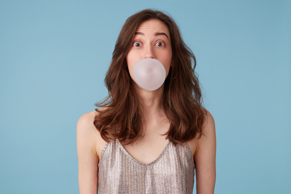 Young Woman Silver Blouse With Bubblegum