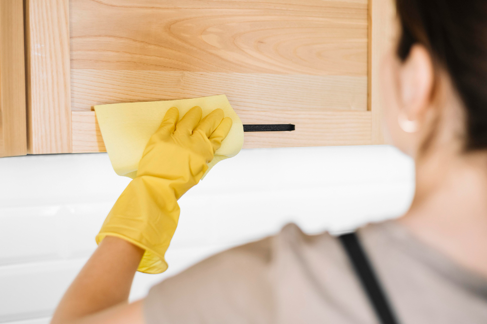 close-up-woman-cleaning-cabinet