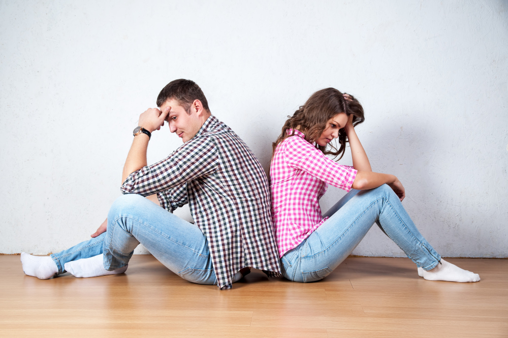 Couple Sitting With Their Backs Turned After Having Argument