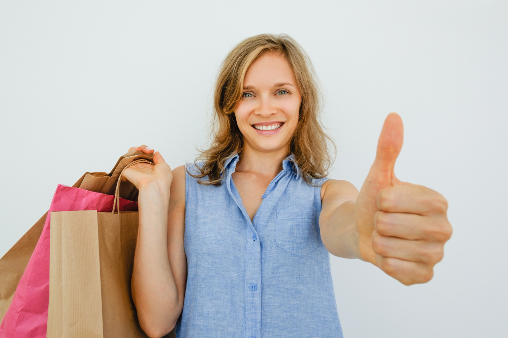 Smiling Woman Holding Bags Showing Thumb Up