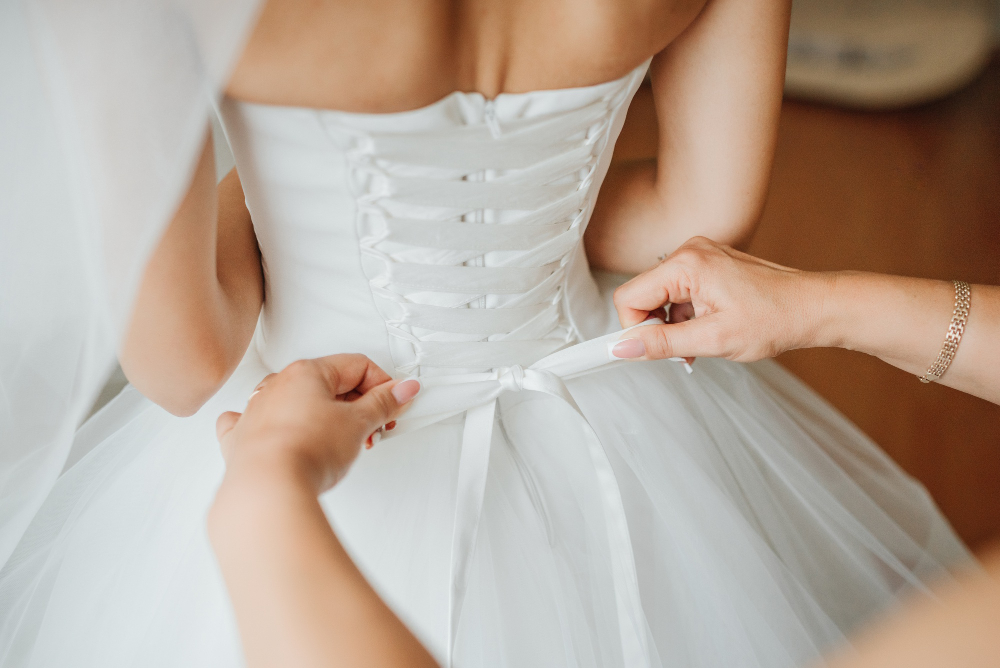 Bridesmaid Makes Bow Knot Back Brides Wedding Dress