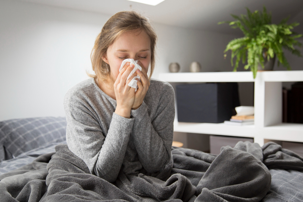 Sick Woman Sitting Bed Blowing Nose With Napkin