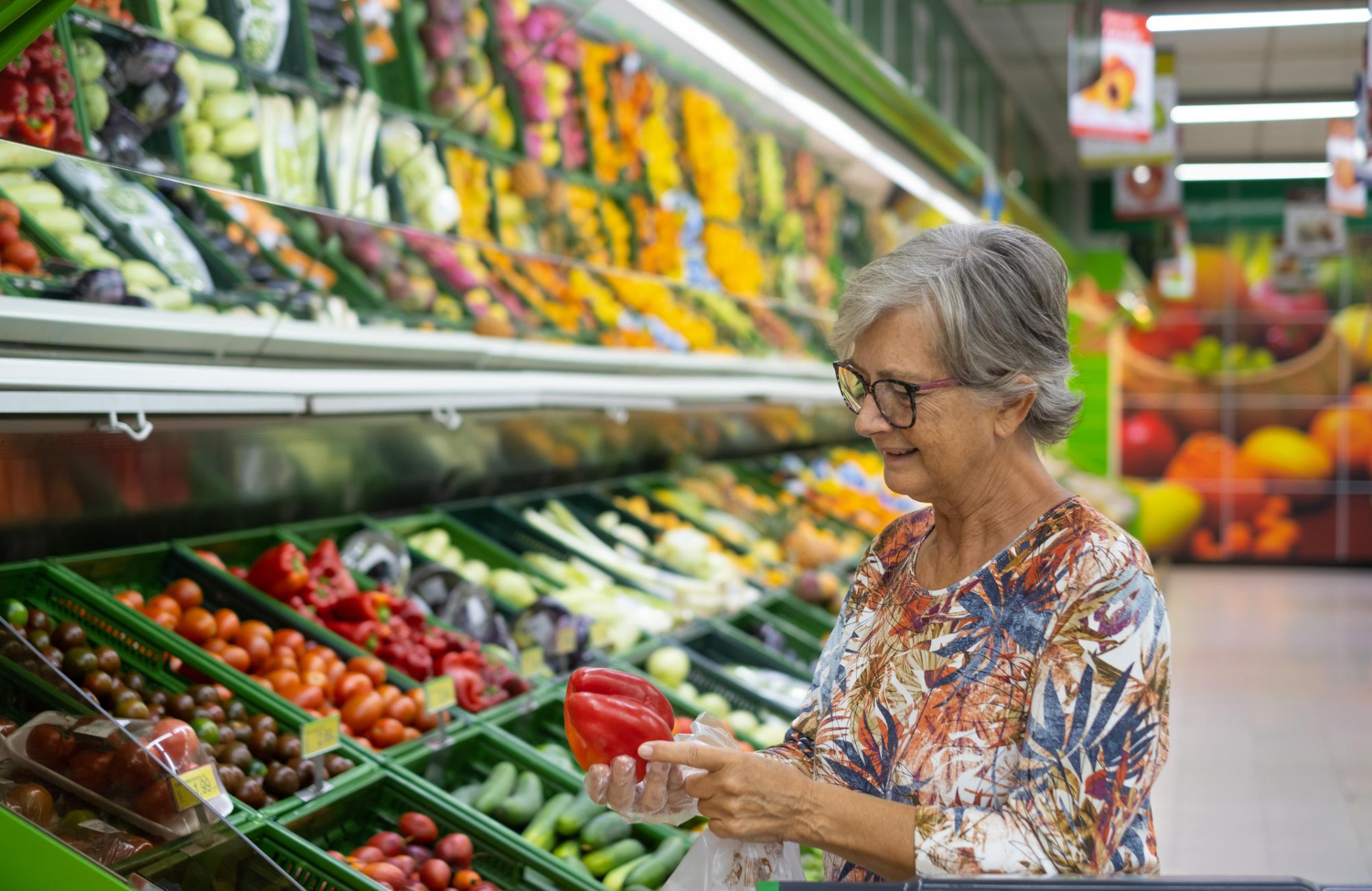 Senior Woman Supermarket Choosing Fresh Vegetables Holding Red Pepper Hands Colorful Mixed Fruit Vegetable Background