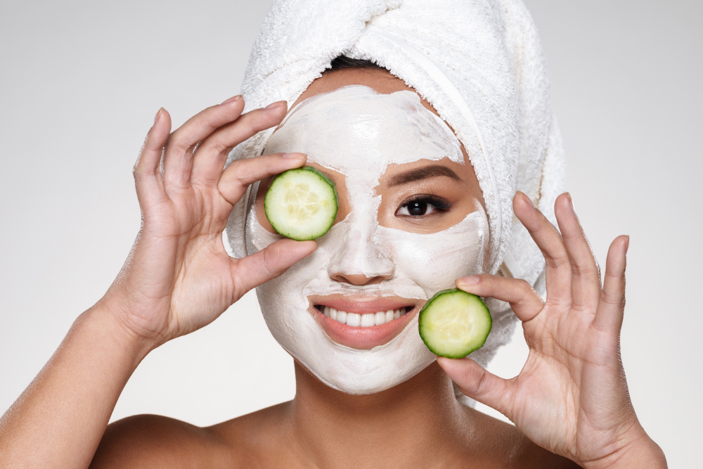 Attractive Smiling Lady With Scrab Face Holding Cucumber Slices