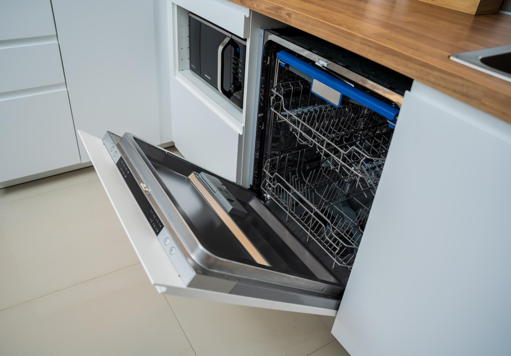 White Kitchen Opened Dishwasher With Clean Dishes (1)
