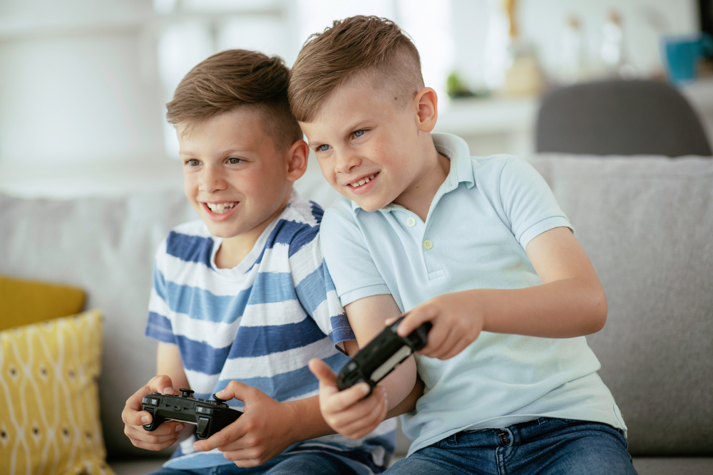 Happy,brothers,playing,video,games.,young,brothers,having,fun,while