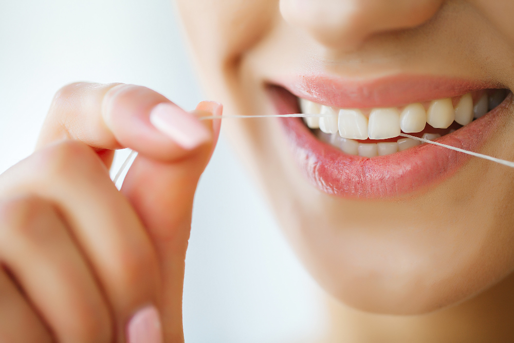 Dental Care Woman With Beautiful Smile Using Floss Teeth Image