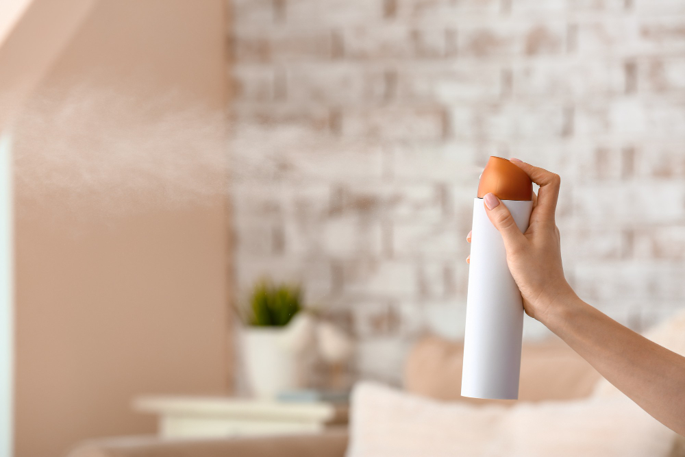 Woman Spraying Air Freshener Room