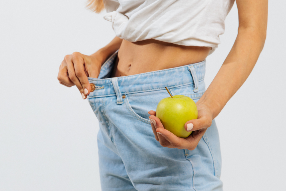 Slim Woman Blue Jeans Holding Green Apple Wearing Oversize Jeans Weight Loss
