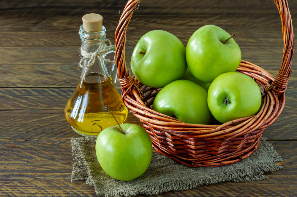 Wicker Basket With Ripe Green Apples Bottle Aplle Vinegar Wooden Background