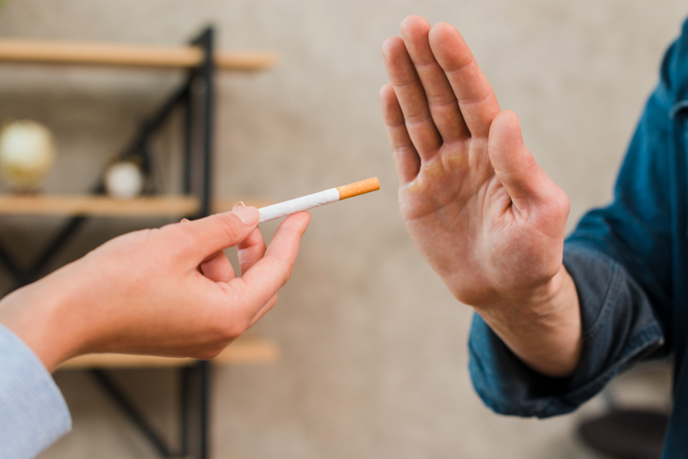 Man Refusing Cigarettes Offered By His Female Colleague