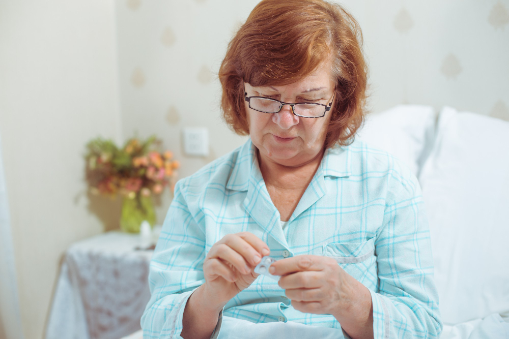 Senior Woman Glassessitting Bed Home Taking Pills Sick Caucasian Red Hair Grandmother
