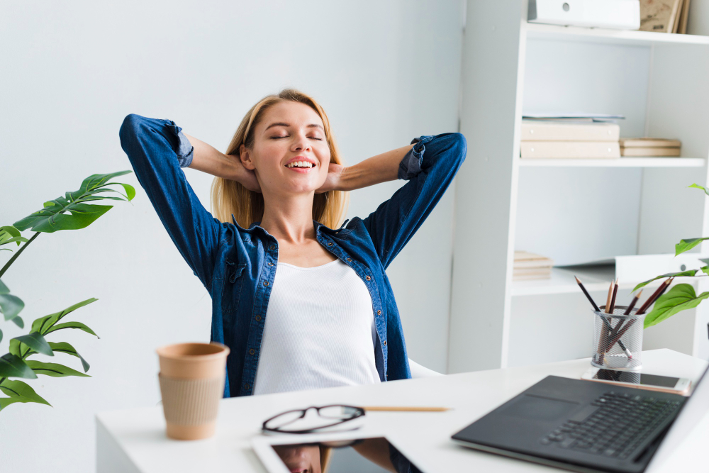 Blond Woman Sitting Back Smiling With Closed Eyes Workplace