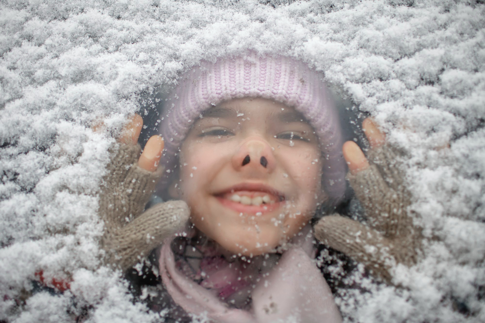 Funny Portrait Girl Warm Cap Through Snowy Car Glass During Winter Family Road Trip